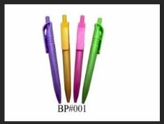 Four retractable ballpoint pens with rubberized grips in purple, gold, pink, and green