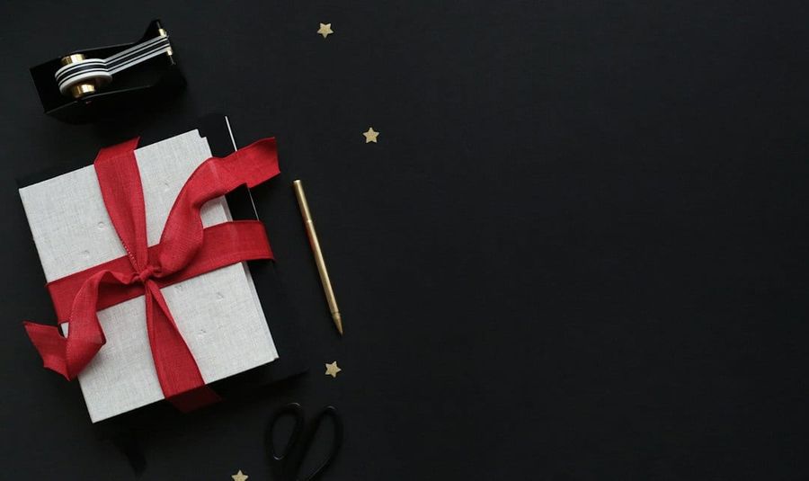 Premium corporate gift merchandise arranged on a navy surface
